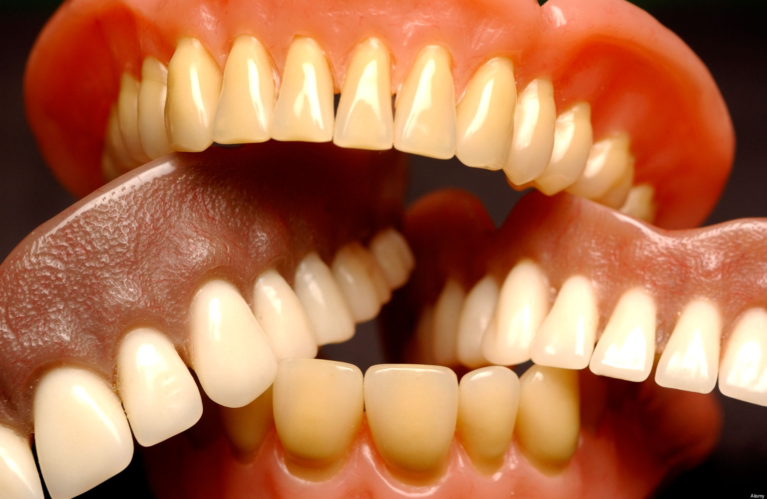 A collection of dentures piled on top of each other.